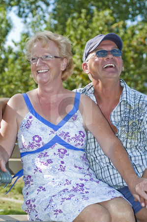 To use this stock image in your creative project, please select the size you need over to the right and click the "Add to Cart" button.
Your downloaded image will come with the Cutcaster watermark removed so don’t worry about the watermark you see on this page. Aged Couple stock photo, Aged couple sitting on a bench and laughing out loud by Vlad Podkhlebnik