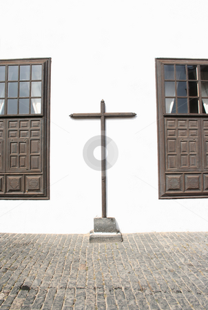 To use this stock image in your creative project, please select the size you need over to the right and click the "Add to Cart" button.
Your downloaded image will come with the Cutcaster watermark removed so don’t worry about the watermark you see on this page. Cross Between two Windows stock photo, A very simple and plain wooden cross attached to the outside wall of a monastery in the town of Teguise, Lanzarote by Helen Shorey
