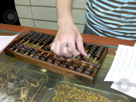 To use this stock image in your creative project, please select the size you need over to the right and click the "Add to Cart" button.
Your downloaded image will come with the Cutcaster watermark removed so don’t worry about the watermark you see on this page. Calculating the price stock photo, An young man is calculating the price of the herbs on an ancient wood
calculator on the counter of his store. by Horst Petzold