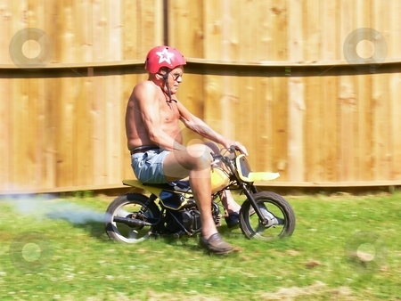 To use this stock image in your creative project, please select the size you need over to the right and click the "Add to Cart" button.
Your downloaded image will come with the Cutcaster watermark removed so don’t worry about the watermark you see on this page. Grandpa on a minibike stock photo, Grandpa in racing on an minibike in his backyard. by Horst Petzold