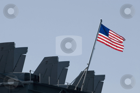 To use this stock image in your creative project, please select the size you need over to the right and click the "Add to Cart" button.
Your downloaded image will come with the Cutcaster watermark removed so don’t worry about the watermark you see on this page. US NAVY stock photo, The stars and stripes flying from the back of the aircraft carrier kitty-hawk by Stephen Gibson