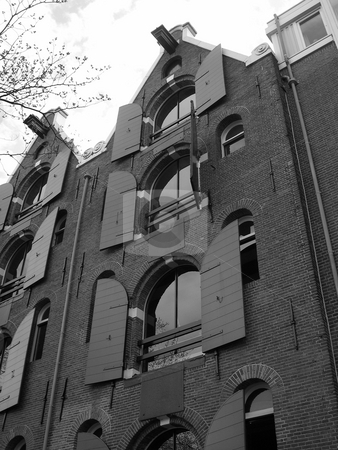 To use this stock image in your creative project, please select the size you need over to the right and click the "Add to Cart" button.
Your downloaded image will come with the Cutcaster watermark removed so don’t worry about the watermark you see on this page. Open shutters in Amsterdam stock photo, Black and white image of building with open shutters in Amsterdam by Jaime Pharr