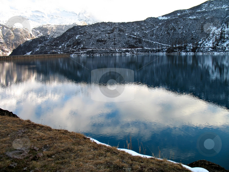 To use this stock image in your creative project, please select the size you need over to the right and click the "Add to Cart" button.
Your downloaded image will come with the Cutcaster watermark removed so don’t worry about the watermark you see on this page. Hydroelectric basin stock photo, An hydroelectric basin in high mountain by Roberto Marinello