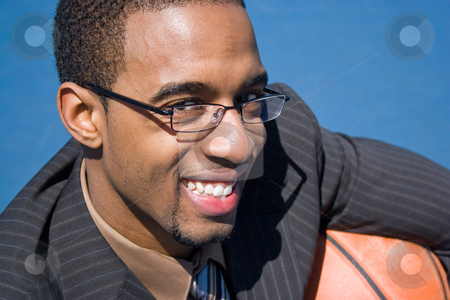 To use this stock image in your creative project, please select the size you need over to the right and click the "Add to Cart" button.
Your downloaded image will come with the Cutcaster watermark removed so don’t worry about the watermark you see on this page. Basketball Pro stock photo, African American man in a business suit posing with a basketball. He could be a coach player recruiter or trainer. by Todd Arena