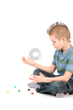 To use this stock image in your creative project, please select the size you need over to the right and click the "Add to Cart" button.
Your downloaded image will come with the Cutcaster watermark removed so don’t worry about the watermark you see on this page. Portrait of young boy with mohawk playing with dice, studio shot stock photo, Portrait of young boy with mohawk playing with dice, studio shot by Tom P.