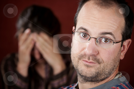 To use this stock image in your creative project, please select the size you need over to the right and click the "Add to Cart" button.
Your downloaded image will come with the Cutcaster watermark removed so don’t worry about the watermark you see on this page. Upset woman and guilty man stock photo, Guilty man with upset woman in the background by Scott Griessel