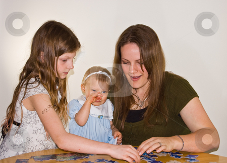 To use this stock image in your creative project, please select the size you need over to the right and click the "Add to Cart" button.
Your downloaded image will come with the Cutcaster watermark removed so don’t worry about the watermark you see on this page. Mom and Girls Doing Puzzle stock photo, This brunette young mom is doing a puzzle with 2 young girls. The baby is rubbing her nose as she's getting sleepy. Family bonding time while learning too. by Valerie Garner