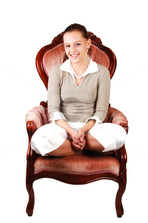 To use this stock image in your creative project, please select the size you need over to the right and click the "Add to Cart" button.
Your downloaded image will come with the Cutcaster watermark removed so don’t worry about the watermark you see on this page. Young pretty woman. stock photo, An lovely smiling young woman with her legs under her butt
sitting in the studio in an armchair and looking at the camera. by Horst Petzold
