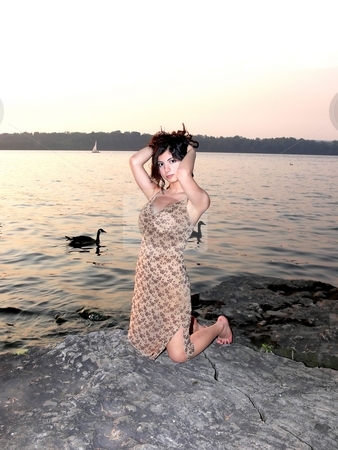 To use this stock image in your creative project, please select the size you need over to the right and click the "Add to Cart" button.
Your downloaded image will come with the Cutcaster watermark removed so don’t worry about the watermark you see on this page. Lady on the lake in sunset stock photo, An lovely young lady kneeling on a big rock on the lake and try to fix her
hair on a nice sunset. by Horst Petzold