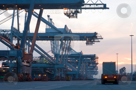 To use this stock image in your creative project, please select the size you need over to the right and click the "Add to Cart" button.
Your downloaded image will come with the Cutcaster watermark removed so don’t worry about the watermark you see on this page. Container Terminal at dusk stock photo, The automated loading and unloading of container ships at Rotterdam Container Terminal continue day and night; the huge cranes waiting for the next container ships' arrival. by Corepics VOF