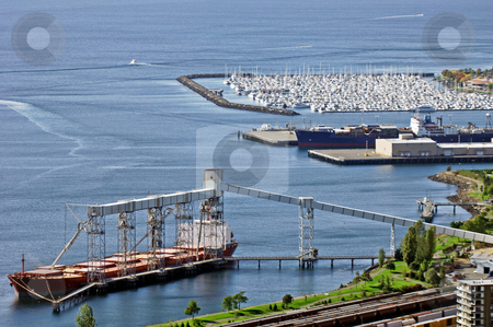 To use this stock image in your creative project, please select the size you need over to the right and click the "Add to Cart" button.
Your downloaded image will come with the Cutcaster watermark removed so don’t worry about the watermark you see on this page. Seattle harbour view stock photo, A vew of Seattle harbor with a huge freighter loading and a marina in the background by Corepics VOF