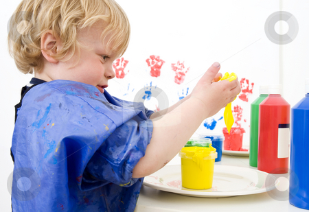 To use this stock image in your creative project, please select the size you need over to the right and click the "Add to Cart" button.
Your downloaded image will come with the Cutcaster watermark removed so don’t worry about the watermark you see on this page. Messing with paint stock photo, Young boy dipping his hands in a pot of finger paint by Corepics VOF