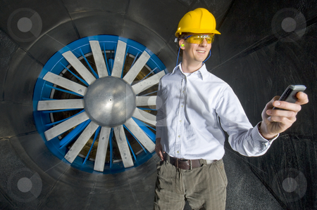 To use this stock image in your creative project, please select the size you need over to the right and click the "Add to Cart" button.
Your downloaded image will come with the Cutcaster watermark removed so don’t worry about the watermark you see on this page. A smiling engineer, looking at his phone stock photo, A smiling engineer, looking at his phone inside the realms of an industrial windtunnel by Corepics VOF