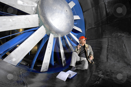 To use this stock image in your creative project, please select the size you need over to the right and click the "Add to Cart" button.
Your downloaded image will come with the Cutcaster watermark removed so don’t worry about the watermark you see on this page. Windtunnel engineer stock photo, An engineer, checking up on the mechanical structure inside a windtunnel by Corepics VOF