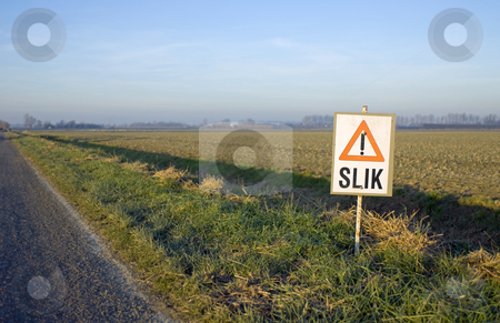 To use this stock image in your creative project, please select the size you need over to the right and click the "Add to Cart" button.
Your downloaded image will come with the Cutcaster watermark removed so don’t worry about the watermark you see on this page. Rural winter stock photo, Low light, looking out over the plowed fields with a warning sign for slipppery mud by Corepics VOF