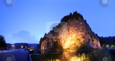 To use this stock image in your creative project, please select the size you need over to the right and click the "Add to Cart" button.
Your downloaded image will come with the Cutcaster watermark removed so don’t worry about the watermark you see on this page. Illuminated Rock Formation stock photo, The massive rock formation, showing the geological lines during its forming in Durbuy, the smallest city in Europe at night by Corepics VOF
