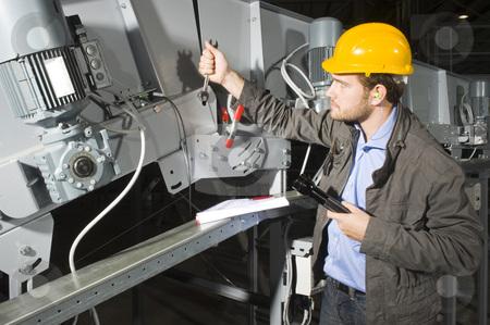 To use this stock image in your creative project, please select the size you need over to the right and click the "Add to Cart" button.
Your downloaded image will come with the Cutcaster watermark removed so don’t worry about the watermark you see on this page. Installation mechanic stock photo, An installation mechanic workingon an industial conveyor belt by Corepics VOF