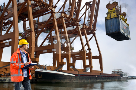 To use this stock image in your creative project, please select the size you need over to the right and click the "Add to Cart" button.
Your downloaded image will come with the Cutcaster watermark removed so don’t worry about the watermark you see on this page. Customs guard stock photo, A customs officr checking containers being unloaded at a commercial harbor by Corepics VOF