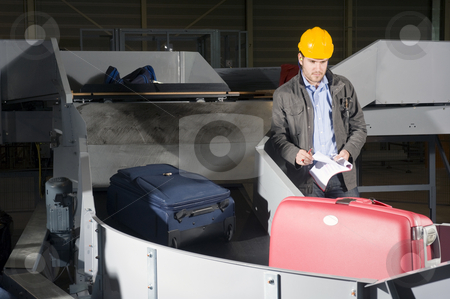 To use this stock image in your creative project, please select the size you need over to the right and click the "Add to Cart" button.
Your downloaded image will come with the Cutcaster watermark removed so don’t worry about the watermark you see on this page. Luggage check at the Airport stock photo, A security staff manually checking luggage after the airport security check at the luggage conveyor belts by Corepics VOF