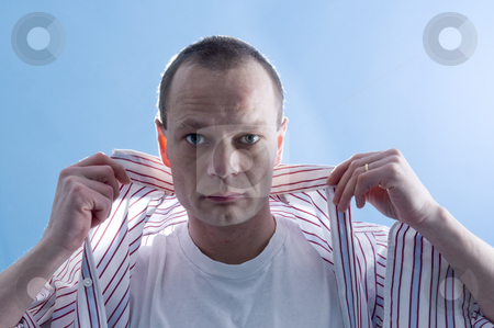 To use this stock image in your creative project, please select the size you need over to the right and click the "Add to Cart" button.
Your downloaded image will come with the Cutcaster watermark removed so don’t worry about the watermark you see on this page. Dressing man stock photo, A man, putting on a dress shirt by Corepics VOF