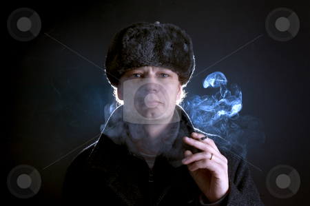 To use this stock image in your creative project, please select the size you need over to the right and click the "Add to Cart" button.
Your downloaded image will come with the Cutcaster watermark removed so don’t worry about the watermark you see on this page. Smoking man stock photo, A man in his 30's, dressed as a former soviet, smoking a cigarette by Corepics VOF