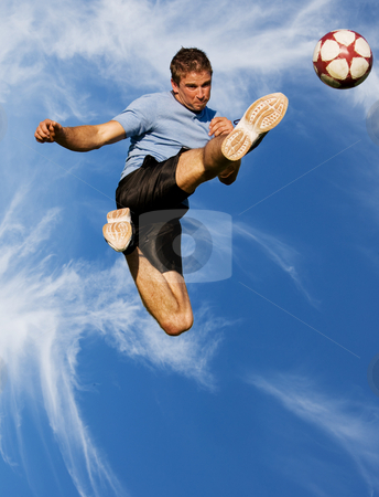 To use this stock image in your creative project, please select the size you need over to the right and click the "Add to Cart" button.
Your downloaded image will come with the Cutcaster watermark removed so don’t worry about the watermark you see on this page. High kick stock photo, Athletic male high in the air kicking a soccer ball by Steve Mcsweeny