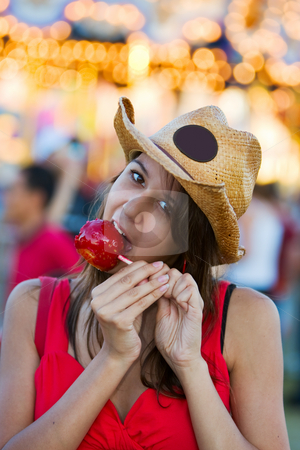 To use this stock image in your creative project, please select the size you need over to the right and click the "Add to Cart" button.
Your downloaded image will come with the Cutcaster watermark removed so don’t worry about the watermark you see on this page. Candy apple snack stock photo, A pretty teen at the fair eating a candy apple by Steve Mcsweeny