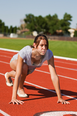 To use this stock image in your creative project, please select the size you need over to the right and click the "Add to Cart" button.
Your downloaded image will come with the Cutcaster watermark removed so don’t worry about the watermark you see on this page. Exercising at the track stock photo, A pretty young woman exercising at the race track by Steve Mcsweeny
