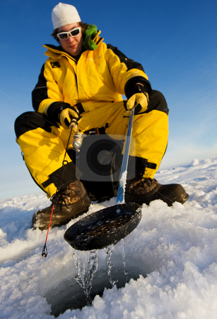 To use this stock image in your creative project, please select the size you need over to the right and click the "Add to Cart" button.
Your downloaded image will come with the Cutcaster watermark removed so don’t worry about the watermark you see on this page. Winter fisherman stock photo, Ice fisherman cleaning ice from the hole with a ladle, focus on the scoop by Steve Mcsweeny