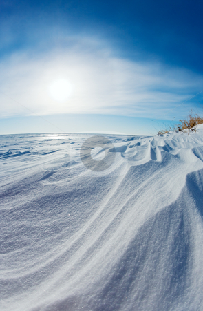 To use this stock image in your creative project, please select the size you need over to the right and click the "Add to Cart" button.
Your downloaded image will come with the Cutcaster watermark removed so don’t worry about the watermark you see on this page. Snow dunes stock photo, Wind swept snow dunes on a frozen lake shore by Steve Mcsweeny