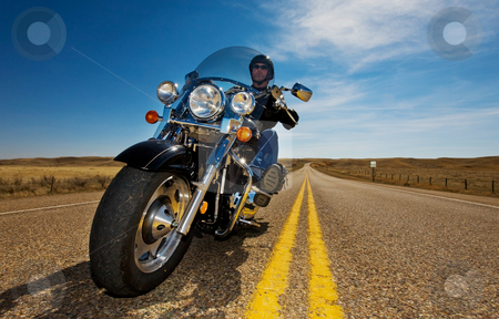 To use this stock image in your creative project, please select the size you need over to the right and click the "Add to Cart" button.
Your downloaded image will come with the Cutcaster watermark removed so don’t worry about the watermark you see on this page. Motorcycle riding stock photo, A biker enjoying a ride in the country side by Steve Mcsweeny
