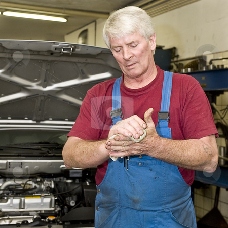 To use this stock image in your creative project, please select the size you need over to the right and click the "Add to Cart" button.
Your downloaded image will come with the Cutcaster watermark removed so don’t worry about the watermark you see on this page. Car mechanic cleaning his hands stock photo, A motor mechanic cleaning his greasy hands after servicing a car. Focus on his hands by Corepics VOF