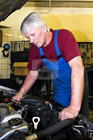To use this stock image in your creative project, please select the size you need over to the right and click the "Add to Cart" button.
Your downloaded image will come with the Cutcaster watermark removed so don’t worry about the watermark you see on this page. Motor mechanic stock photo, A senior motor mechanic servicing a car inside a garage by Corepics VOF