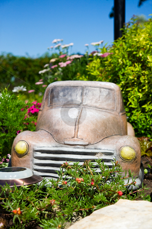 To use this stock image in your creative project, please select the size you need over to the right and click the "Add to Cart" button.
Your downloaded image will come with the Cutcaster watermark removed so don’t worry about the watermark you see on this page. Truck in Flower Bed stock photo, An old truck ornament in a lush, sunny, flower bed. Shallow depth of field. Focus on front of truck. by Brenda Carson