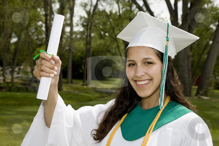 To use this stock image in your creative project, please select the size you need over to the right and click the "Add to Cart" button.
Your downloaded image will come with the Cutcaster watermark removed so don’t worry about the watermark you see on this page. Proud Graduate stock photo, A beautiful, mixed-race student proudly holding up her degree. by Brenda Carson
