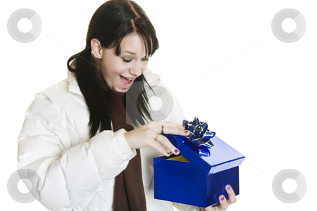 To use this stock image in your creative project, please select the size you need over to the right and click the "Add to Cart" button.
Your downloaded image will come with the Cutcaster watermark removed so don’t worry about the watermark you see on this page. Surprise Christmas Gift stock photo, A surprised girl opening her Christmas gift. by Brenda Carson