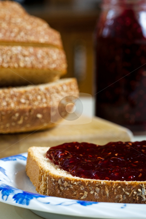 To use this stock image in your creative project, please select the size you need over to the right and click the "Add to Cart" button.
Your downloaded image will come with the Cutcaster watermark removed so don’t worry about the watermark you see on this page. Bread and Jam stock photo, A thick layer of tangy raspberry jam, on whole wheat multi-grain bread. Focus on bread. by Brenda Carson