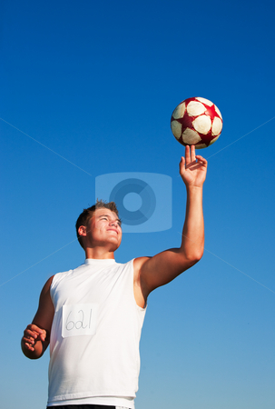 To use this stock image in your creative project, please select the size you need over to the right and click the "Add to Cart" button.
Your downloaded image will come with the Cutcaster watermark removed so don’t worry about the watermark you see on this page. Spinning Soccer Ball stock photo, A young man spinning a soccer ball on his finger in the warm summer sun. by Brenda Carson