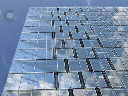 To use this stock image in your creative project, please select the size you need over to the right and click the "Add to Cart" button.
Your downloaded image will come with the Cutcaster watermark removed so don’t worry about the watermark you see on this page. Geometric Windows Office Building stock photo, Modern architecture with glass windows by Birgit Reitz-Hofmann