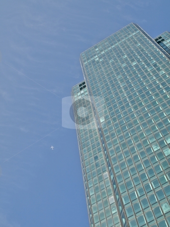 To use this stock image in your creative project, please select the size you need over to the right and click the "Add to Cart" button.
Your downloaded image will come with the Cutcaster watermark removed so don’t worry about the watermark you see on this page. Green skyscraper and jet plane stock photo, Green skyscraper and jet plane under blue sky by Laurent Dambies