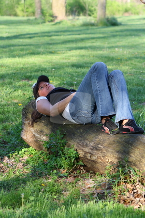 To use this stock image in your creative project, please select the size you need over to the right and click the "Add to Cart" button.
Your downloaded image will come with the Cutcaster watermark removed so don’t worry about the watermark you see on this page. Woman resting on a log stock photo, Rebecca stops to rest and enjoy the warm sunny spring day. by Chris Torres