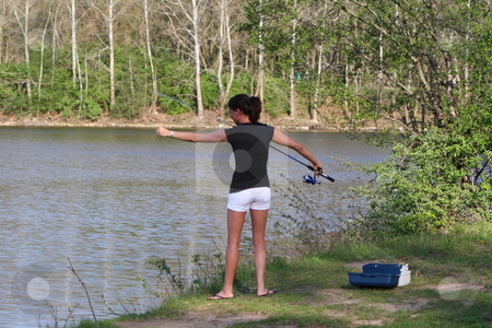 To use this stock image in your creative project, please select the size you need over to the right and click the "Add to Cart" button.
Your downloaded image will come with the Cutcaster watermark removed so don’t worry about the watermark you see on this page. A Beautiful Young Woman Fishing stock photo, Rebeka brings her tackle box and an open reel fishing pole for a day of fishing at the lake. by Chris Torres