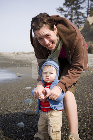 To use this stock image in your creative project, please select the size you need over to the right and click the "Add to Cart" button.
Your downloaded image will come with the Cutcaster watermark removed so don’t worry about the watermark you see on this page. Mother and Son stock photo, A young mother and her son having fun at the beach. by Travis Manley