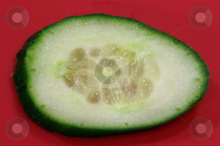 To use this stock image in your creative project, please select the size you need over to the right and click the "Add to Cart" button.
Your downloaded image will come with the Cutcaster watermark removed so don’t worry about the watermark you see on this page. Cucumber slice stock photo, Cucumber slice on red background by Birgit Reitz-Hofmann