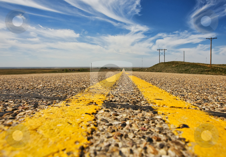 To use this stock image in your creative project, please select the size you need over to the right and click the "Add to Cart" button.
Your downloaded image will come with the Cutcaster watermark removed so don’t worry about the watermark you see on this page. Rural road stock photo, A low angle view of a rural highway by Steve Mcsweeny