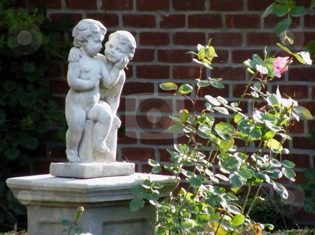 To use this stock image in your creative project, please select the size you need over to the right and click the "Add to Cart" button.
Your downloaded image will come with the Cutcaster watermark removed so don’t worry about the watermark you see on this page. Garden Statue stock photo, Garden Statue beside a flowering rose bush. by Dazz Lee Photography