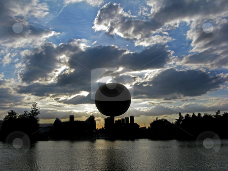 To use this stock image in your creative project, please select the size you need over to the right and click the "Add to Cart" button.
Your downloaded image will come with the Cutcaster watermark removed so don’t worry about the watermark you see on this page. Balloon Silhouette Sunset stock photo, A silhouette of a balloon and surroundings at sunset across a lake. by Lucy Clark