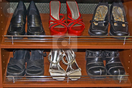 To use this stock image in your creative project, please select the size you need over to the right and click the "Add to Cart" button.
Your downloaded image will come with the Cutcaster watermark removed so don’t worry about the watermark you see on this page. Closet of Shoes stock photo, A two row closet of shoes with red high heels, silver and several pair of black shoes in wood shelves. by Valerie Garner