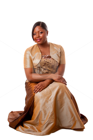 To use this stock image in your creative project, please select the size you need over to the right and click the "Add to Cart" button.
Your downloaded image will come with the Cutcaster watermark removed so don’t worry about the watermark you see on this page. Beautiful African woman stock photo, Beautiful African American woman in brown with gold dress, sitting, isolated by Paul Hakimata