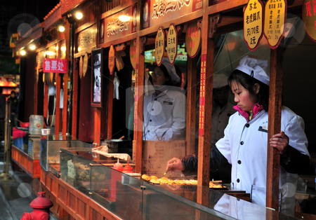 To use this stock image in your creative project, please select the size you need over to the right and click the "Add to Cart" button.
Your downloaded image will come with the Cutcaster watermark removed so don’t worry about the watermark you see on this page. Chinese food seller stock photo, Chinese food seller in the street of Shanghai China by Kobby Dagan